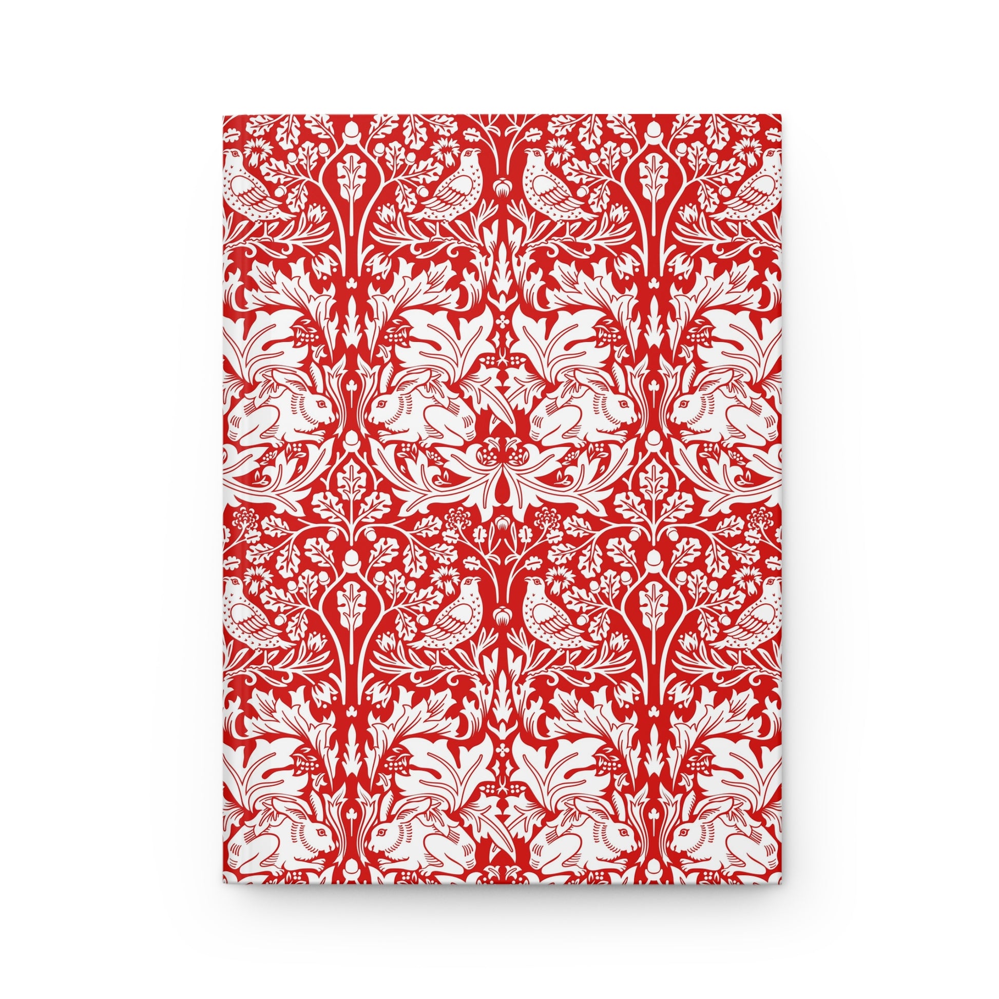 Notebook with red and white floral and bird pattern on a white background