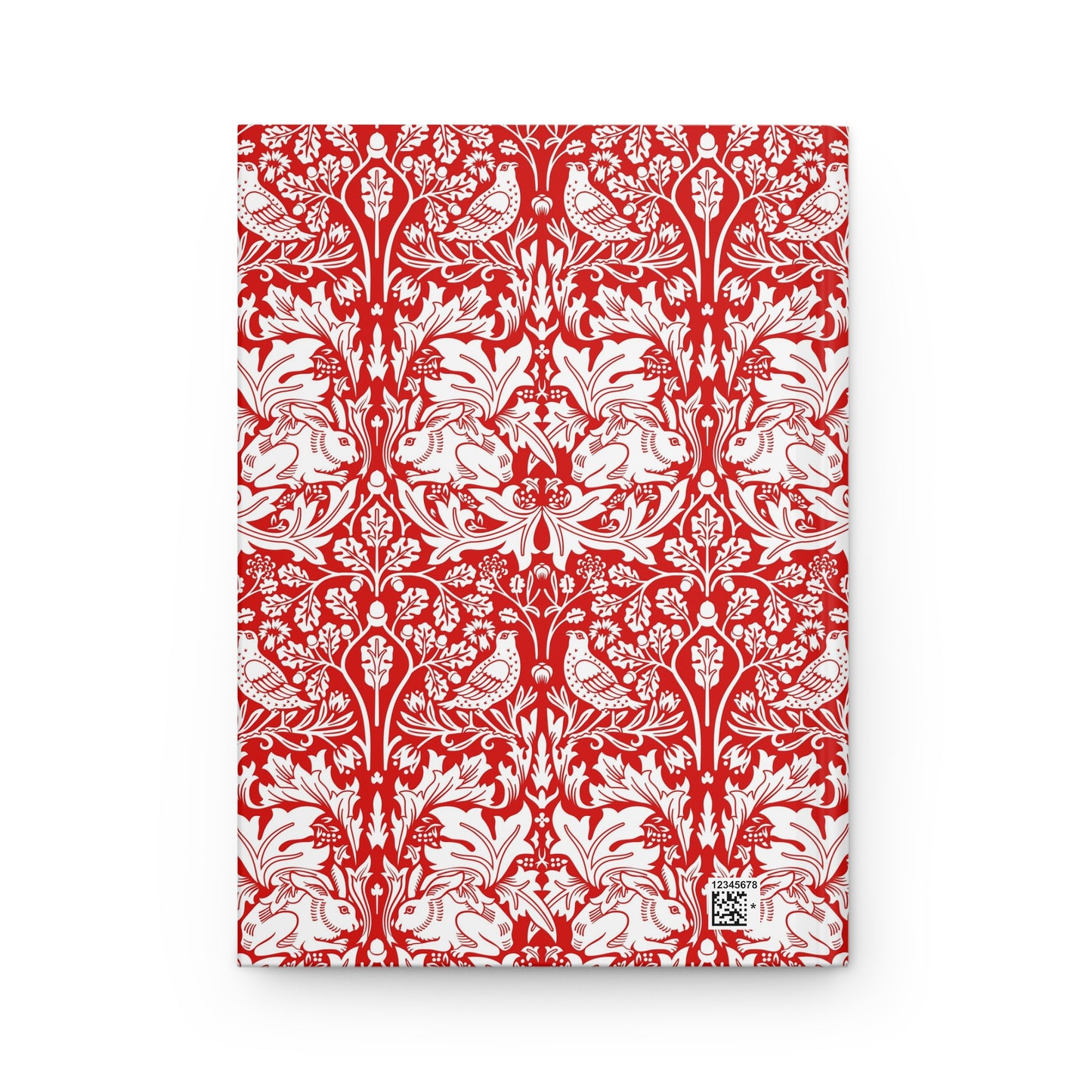Red notebook with white floral and bird pattern on a white background