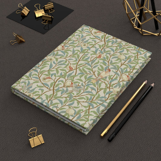 Light yellow notebook with text on a dark surface with office supplies