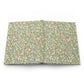 Floral patterned open notebook on a white background