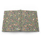Patterned William Morris & Co notebook with green leaves and red berries on a pink background