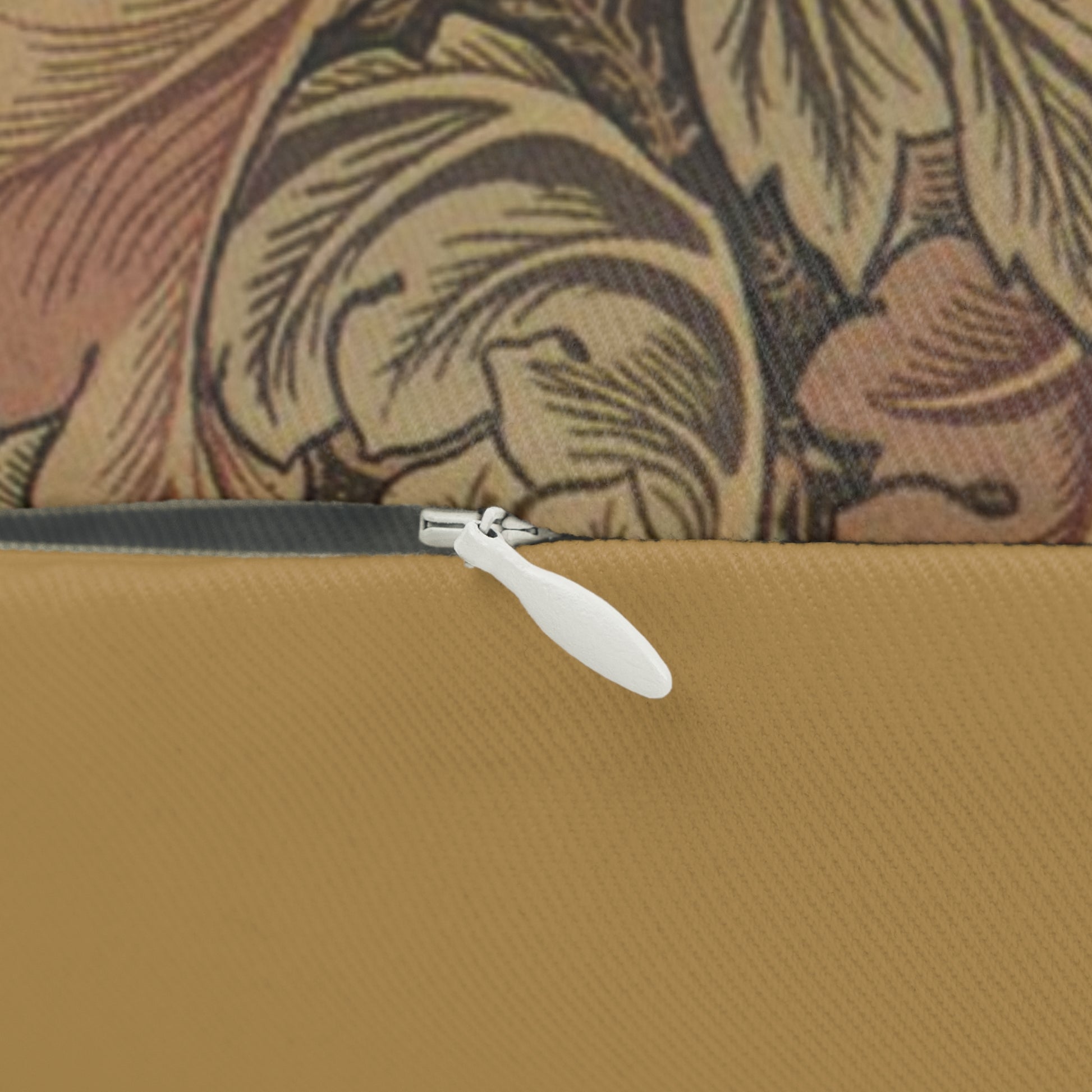 A rectangular lumbar cushion with a William Morris & Co floral pattern in brown, beige, and green colours, featuring a concealed zipper.