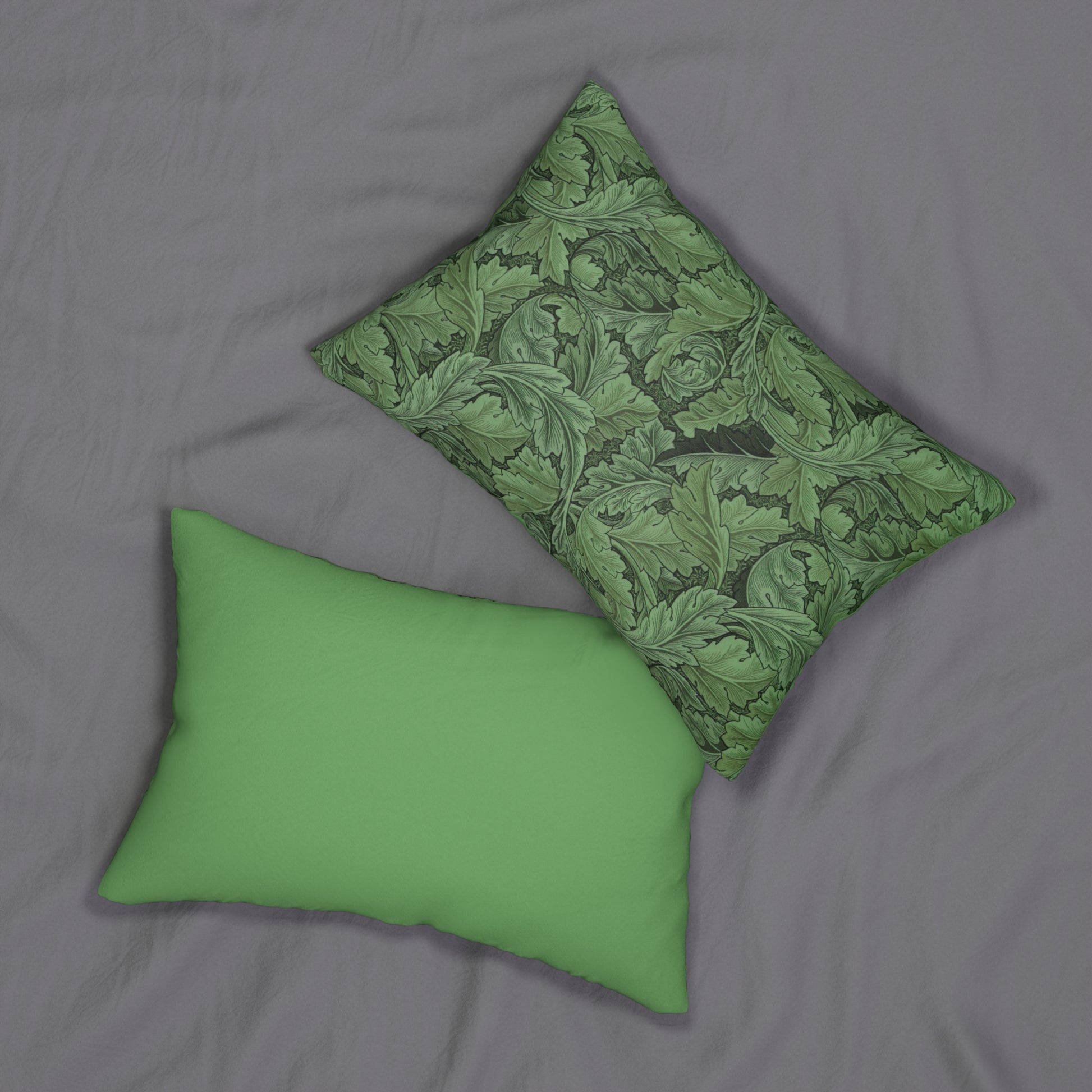 A green lumbar cushion with a floral William Morris & Co pattern, featuring a hidden beige zipper.