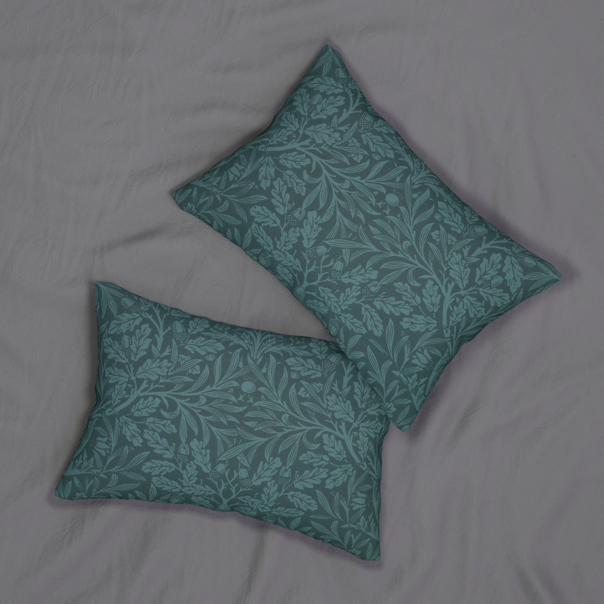Two square decorative throw pillows with a teal and gray damask botanical pattern, arranged on a light gray textured fabric background.