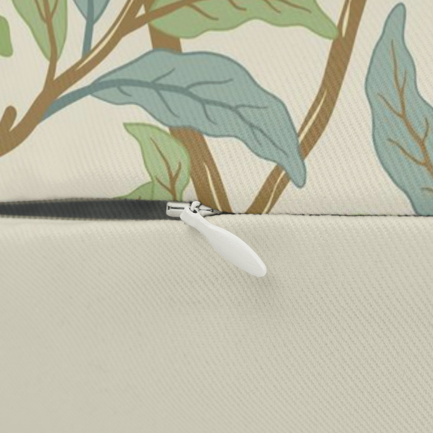 A rectangular William Morris & Co lumbar cushion with a bird and pomegranate design on a light background, featuring a concealed zipper.