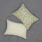 A rectangular William Morris & Co lumbar cushion with a bird and pomegranate design on a light background, featuring a concealed zipper.