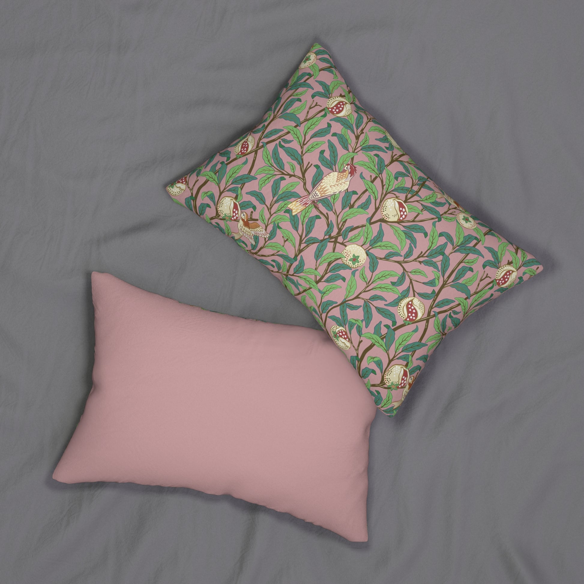 Rectangular lumbar cushion with a floral and bird design inspired by William Morris, in predominantly green and pink colours.
