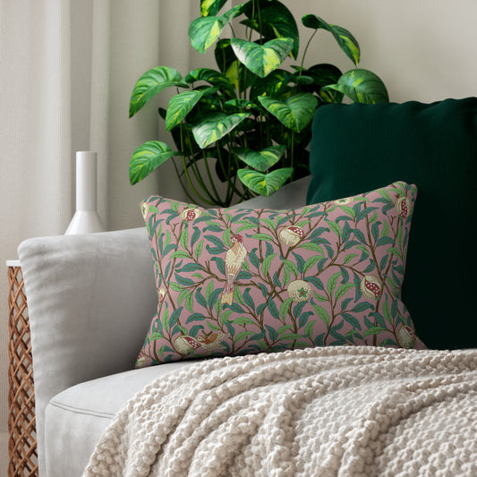 Rectangular lumbar cushion with a floral and bird design inspired by William Morris, in predominantly green and pink colours.