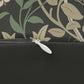 A rectangular William Morris inspired lumbar cushion with a floral pattern in beige, green, and red hues.