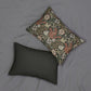 A rectangular William Morris inspired lumbar cushion with a floral pattern in beige, green, and red hues.