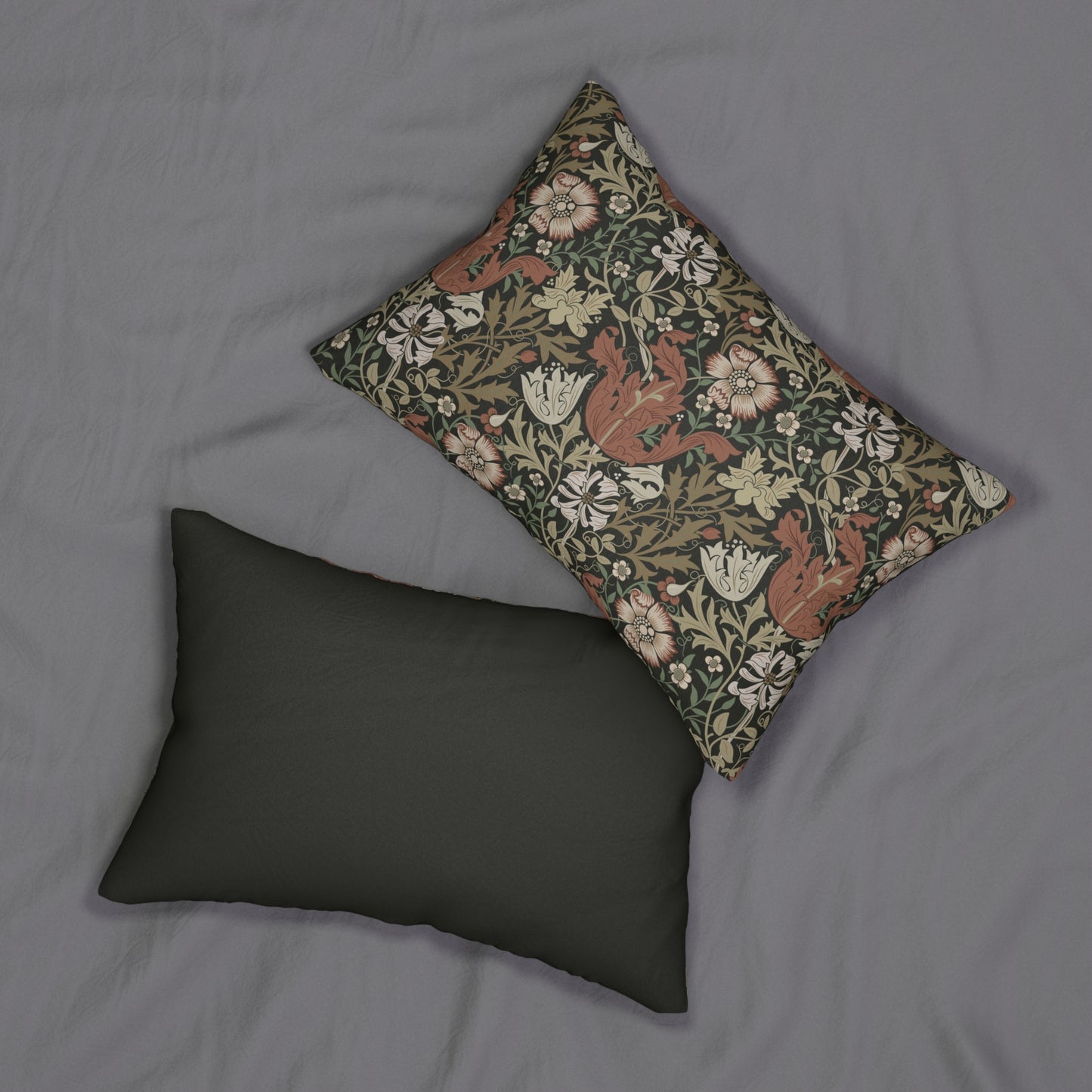 A rectangular William Morris inspired lumbar cushion with a floral pattern in beige, green, and red hues.
