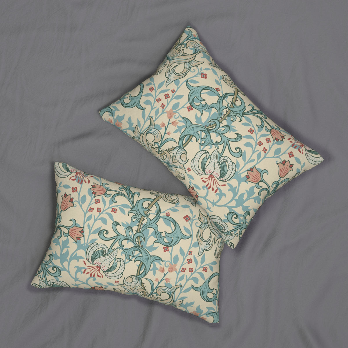 Two decorative throw pillows with a classic William Morris-style floral and scroll pattern in teal, dusty pink, and cream, arranged on a textured gray fabric background.