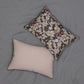A rectangular lumbar cushion with a floral William Morris & Co pattern in muted colours on a dark background, featuring a concealed zipper.