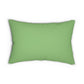 A rectangular lumbar cushion with a green William Morris & Co floral pattern on a green background, featuring a concealed beige zipper.