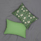A rectangular lumbar cushion with a green William Morris & Co floral pattern on a green background, featuring a concealed beige zipper.