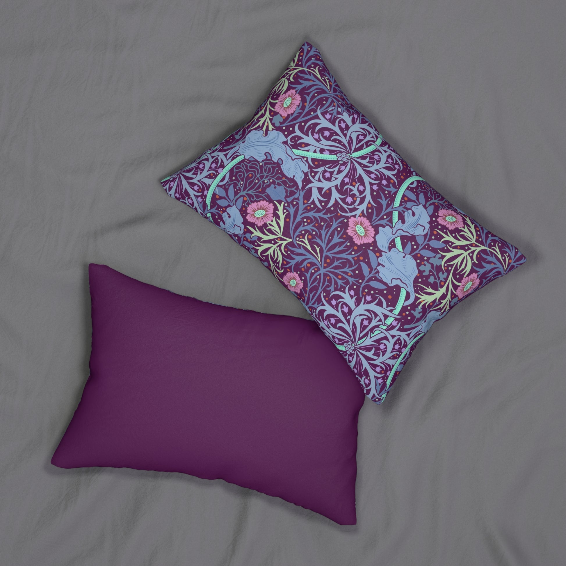 Rectangular lumbar cushion with a William Morris & Co floral pattern in pink, green, and purple colours