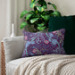 Rectangular lumbar cushion with a William Morris & Co floral pattern in pink, green, and purple colours