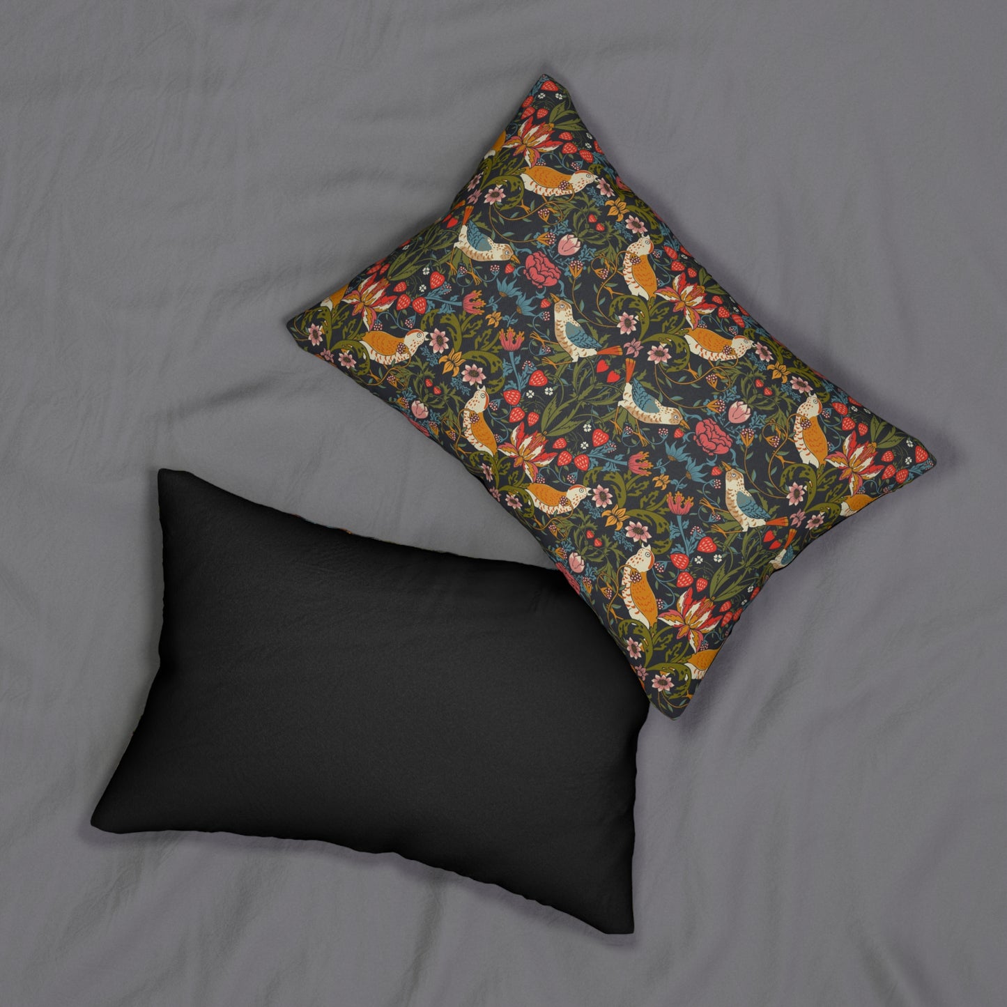 Two pillows on a gray background, one black and one with a floral pattern.