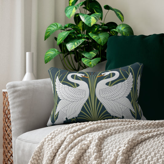 A decorative lumbar cushion featuring a white swan design on a darker background, with a floral William Morris & Co pattern in the background.