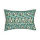 A rectangular decorative throw pillow featuring a dense floral and botanical pattern in teal, green, cream, and black, set against a plain white background.