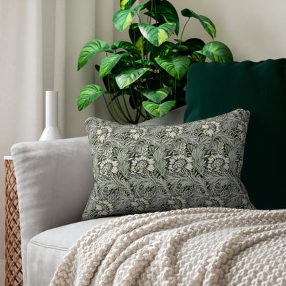 Decorative pillow with floral pattern on a couch next to a plant