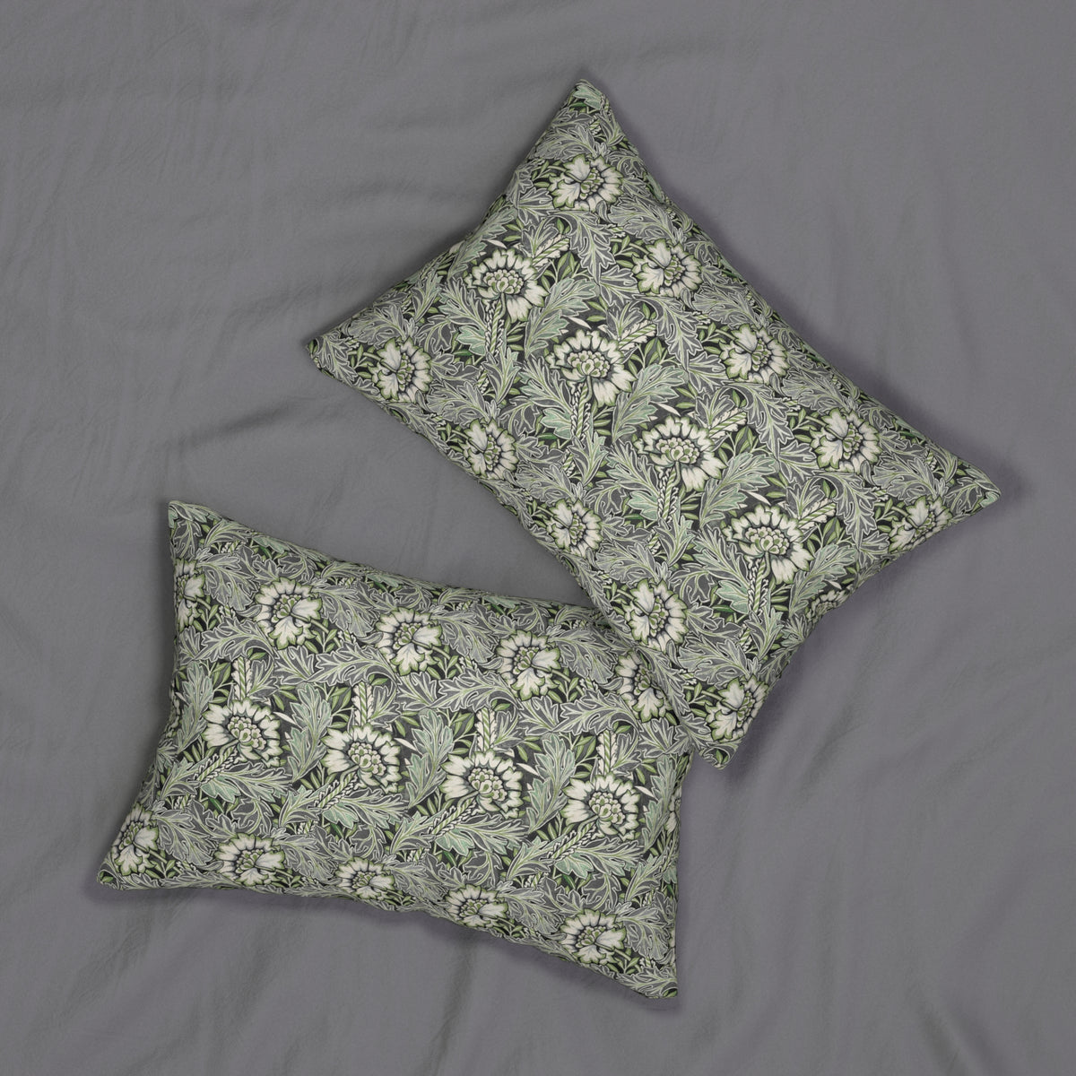 Two rectangular decorative pillows with a green and white floral pattern, arranged on a gray fabric background.