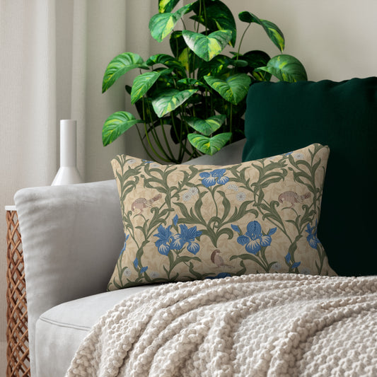 A rectangular lumbar cushion with a William Morris & Co floral pattern featuring blue irises, beige, and green colours on a white background with a concealed zipper.