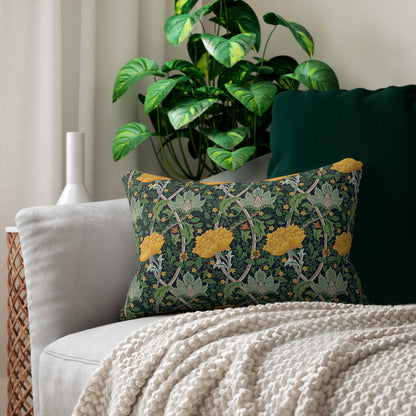 Decorative pillow with holly design on a couch with a plant in the background