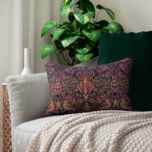 A rectangular decorative throw pillow featuring a dense, symmetrical Art Nouveau William Morris & Co pattern with stylised trees, leaves, and birds in coral pink, olive green and mustard yellow on a dark navy background.