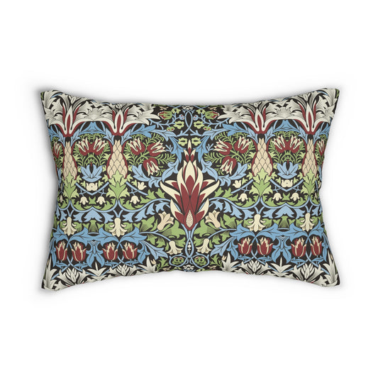 A rectangular lumbar cushion with a William Morris & Co floral and geometric pattern in multiple colours, including blue, beige, and green, with a concealed beige zipper.