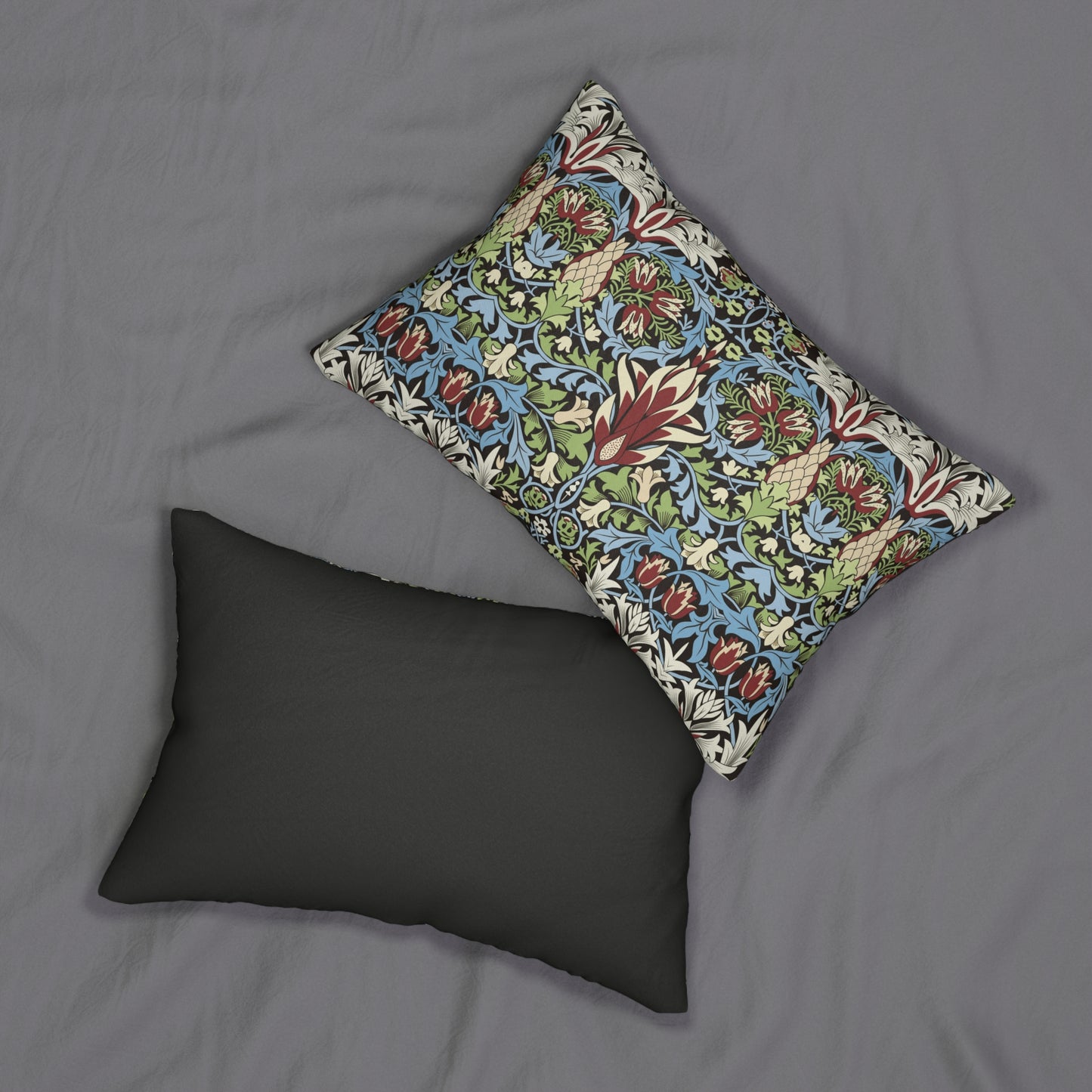 A rectangular lumbar cushion with a William Morris & Co floral and geometric pattern in multiple colours, including blue, beige, and green, with a concealed beige zipper.