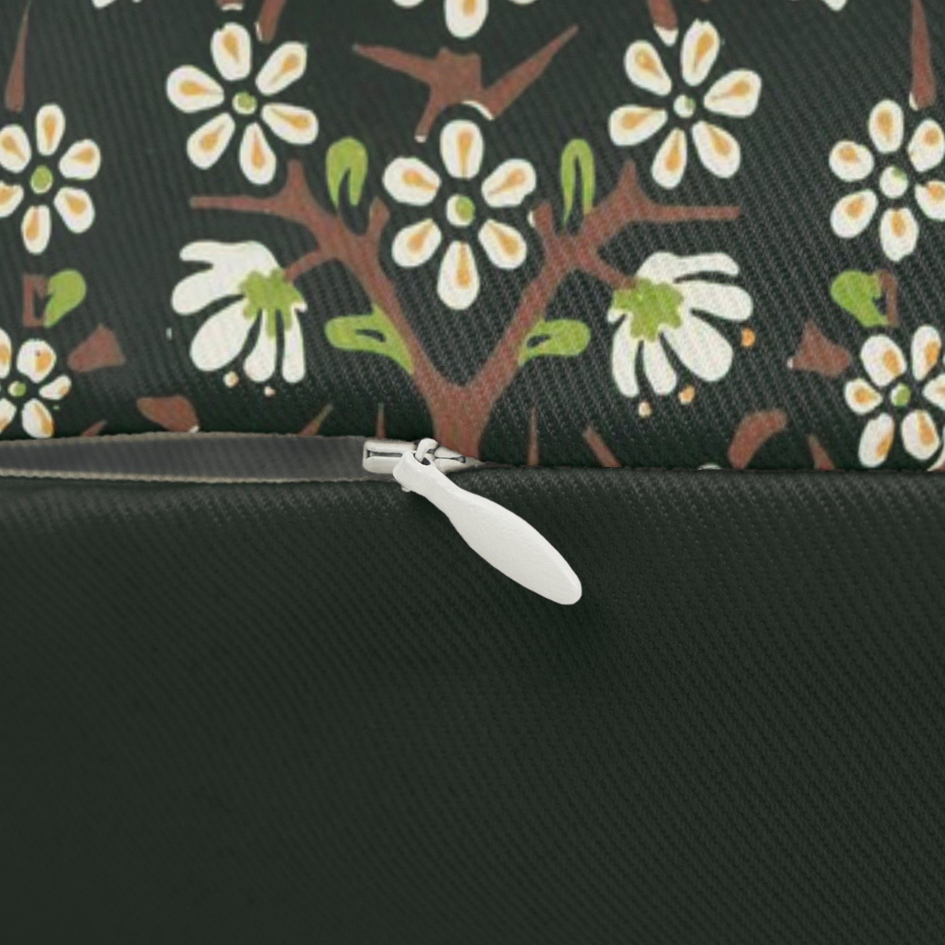 A rectangular lumbar cushion with a floral William Morris & Co pattern in red, green, and blue hues, featuring a hidden beige zipper.