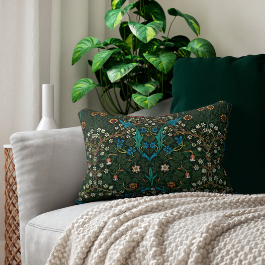 A rectangular lumbar cushion with a floral William Morris & Co pattern in red, green, and blue hues, featuring a hidden beige zipper.