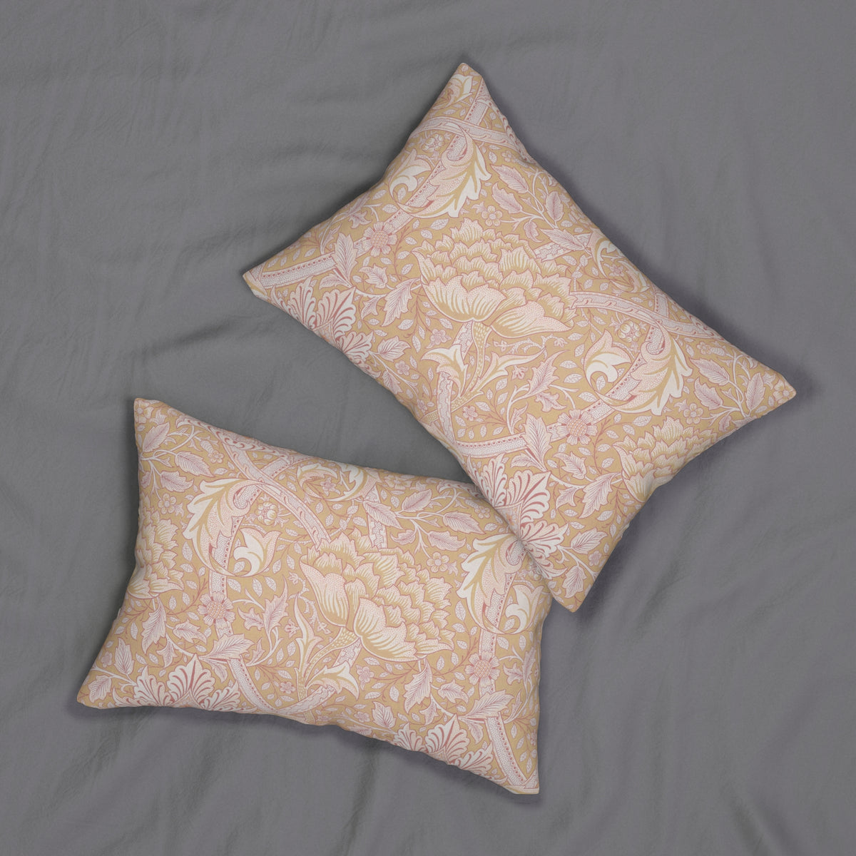 Two beige pillows with white floral patterns on a gray background