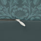 A rectangular lumbar cushion with a William Morris & Co floral pattern in teal colour, featuring acorn and oak leaves.