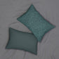 A rectangular lumbar cushion with a William Morris & Co floral pattern in teal colour, featuring acorn and oak leaves.