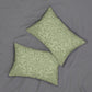 Two rectangular decorative throw pillows with a sage green and cream damask botanical pattern, arranged on a textured gray fabric background.