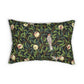 A rectangular decorative throw pillow featuring a classic William Morris-style floral and bird pattern with green leaves, brown branches, and red-and-white pomegranate motifs on a dark background.