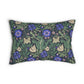 A rectangular decorative throw pillow featuring a dense floral and botanical pattern with blue flowers, green leaves, and beige butterflies on a dark background, shown against a plain white studio backdrop.