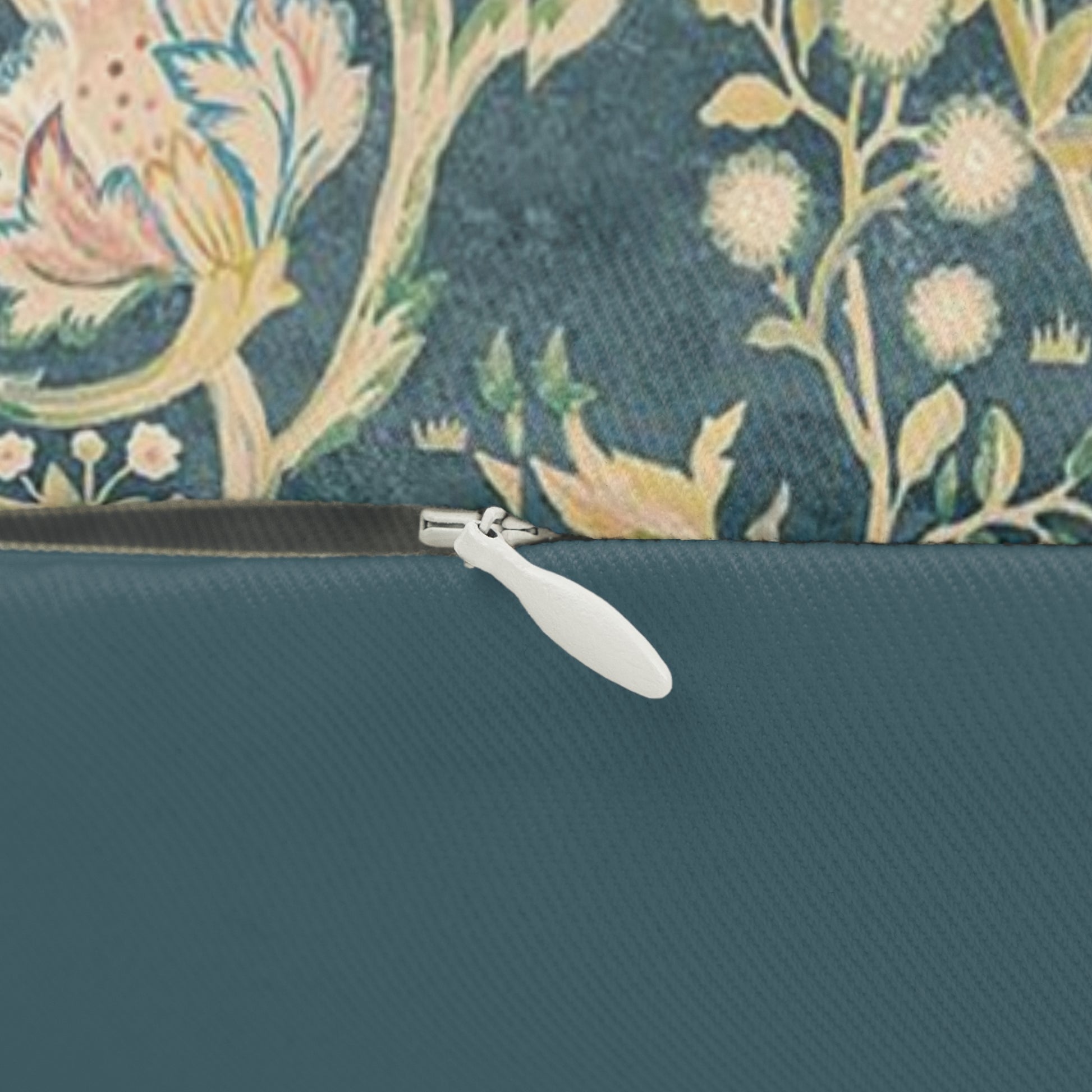 Rectangular lumbar cushion with a floral William Morris & Co pattern in various colours on a teal background.