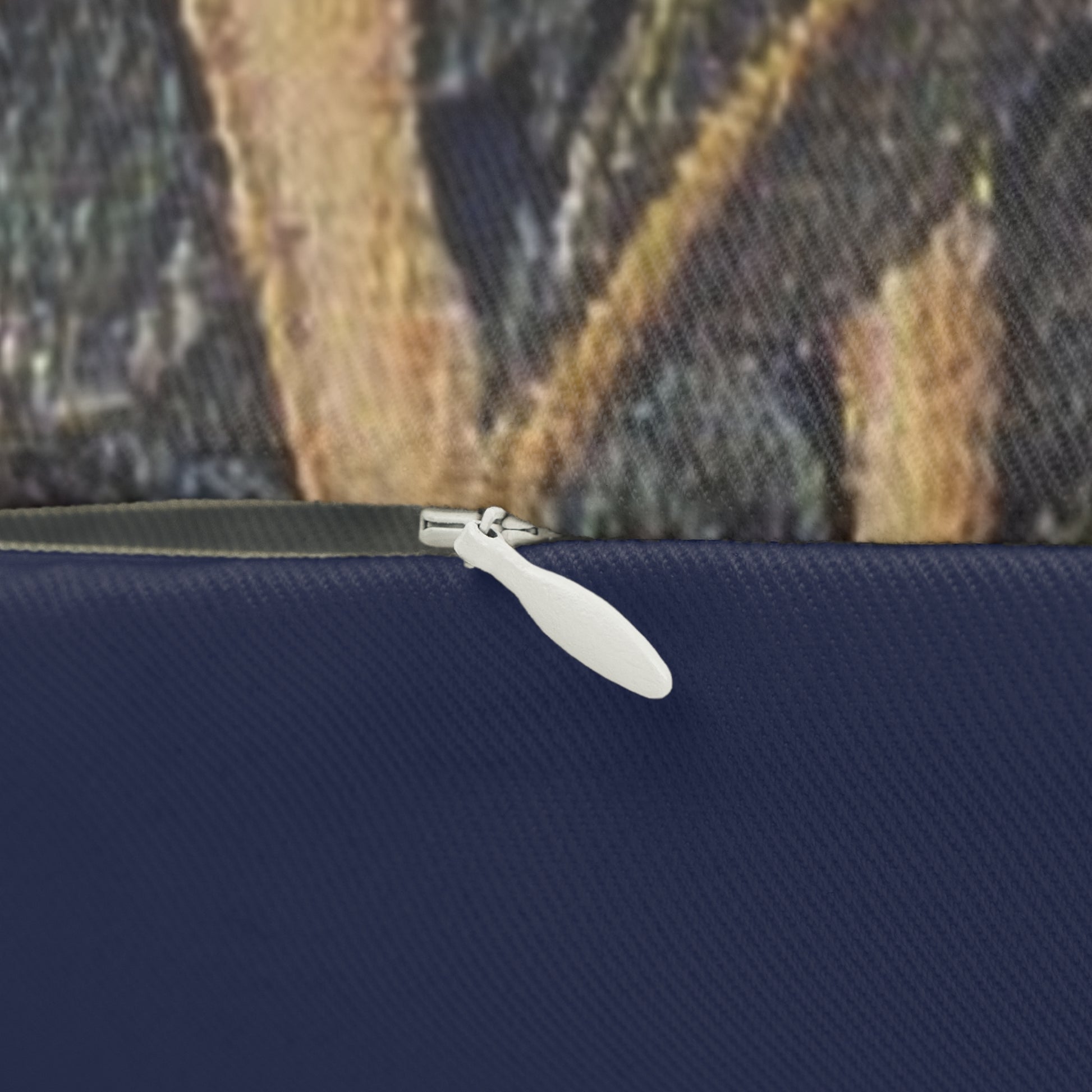 A rectangular lumbar cushion with an ornate design featuring birds, fruit, and leaves on a dark background, inspired by William Morris's art.