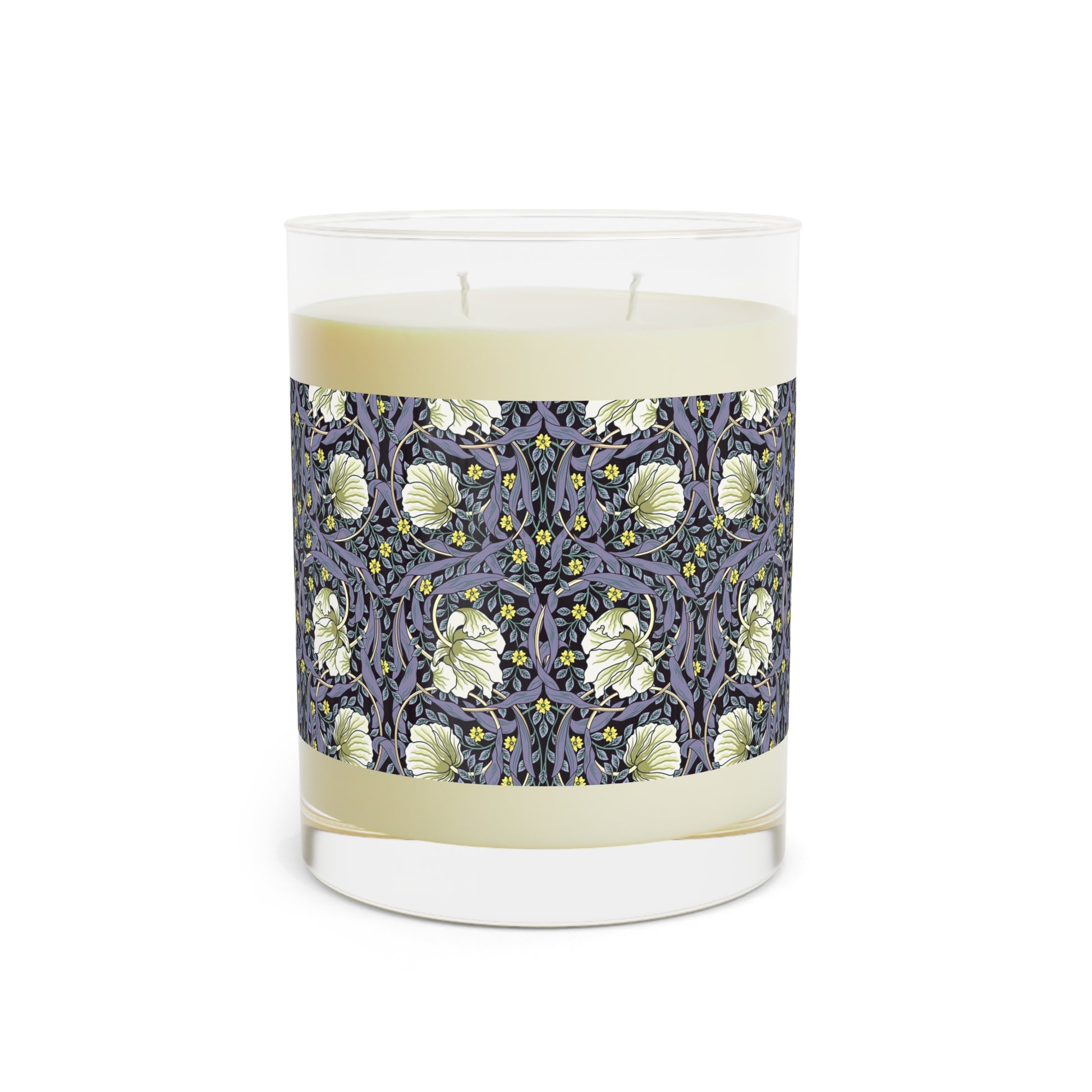 A clear candle with a lavender and sage William Morris & Co design called Pimpernel on the glass lid, alongside a brown cardboard lid with product information.