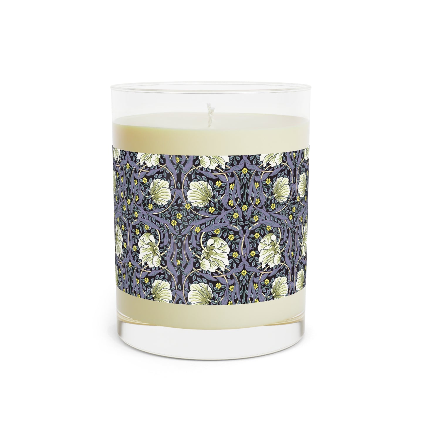 A clear candle with a lavender and sage William Morris & Co design called Pimpernel on the glass lid, alongside a brown cardboard lid with product information.