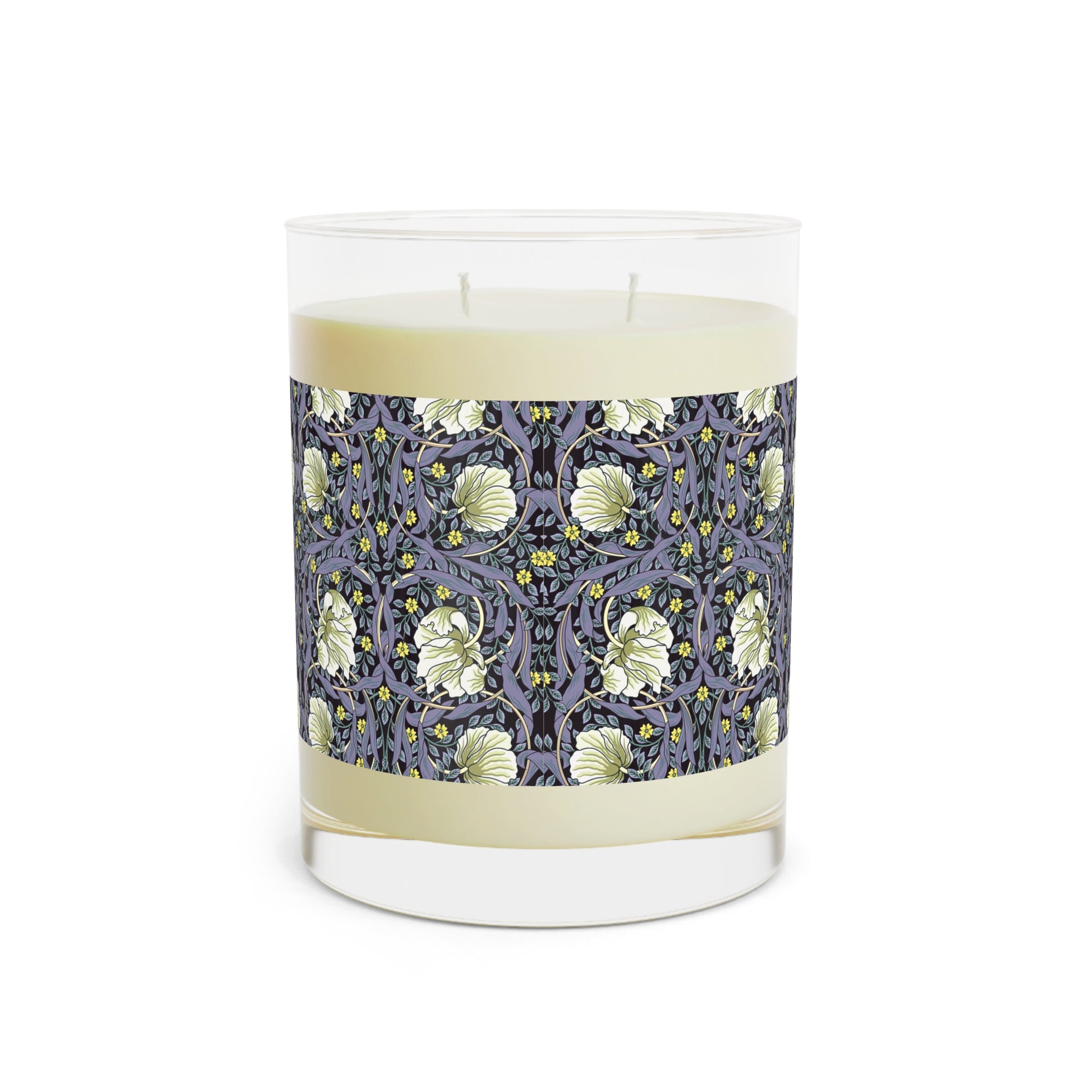 A clear candle with a lavender and sage William Morris & Co design called Pimpernel on the glass lid, alongside a brown cardboard lid with product information.