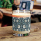 A clear glass candle with a William Morris & Co floral patterned lid and a label that reads 'Seventh Ave White Tea & Fig' alongside a brown cardboard lid.