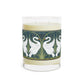 A clear glass candle with a white swan design on the label, alongside a brown cardboard lid with text.
