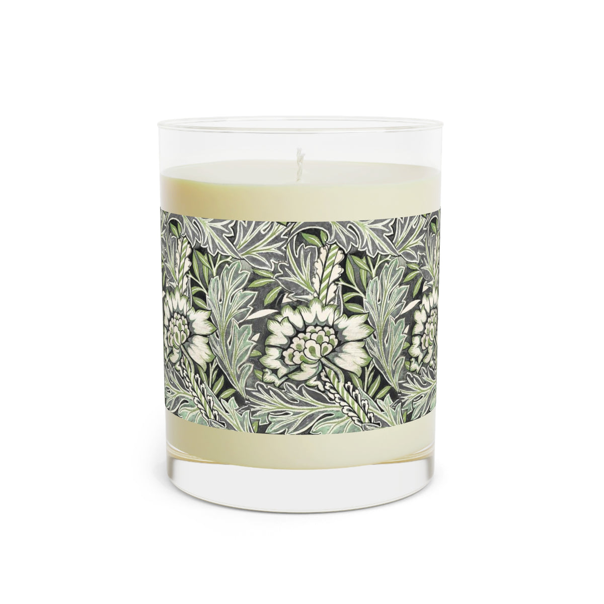 A clear glass jar candle with pale cream wax and a decorative paper label featuring a botanical pattern of white flowers and green leaves on a gray background.