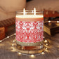 Candle with red floral pattern and wooden lid on a white background