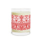 Candle with a red and white patterned label on a white background