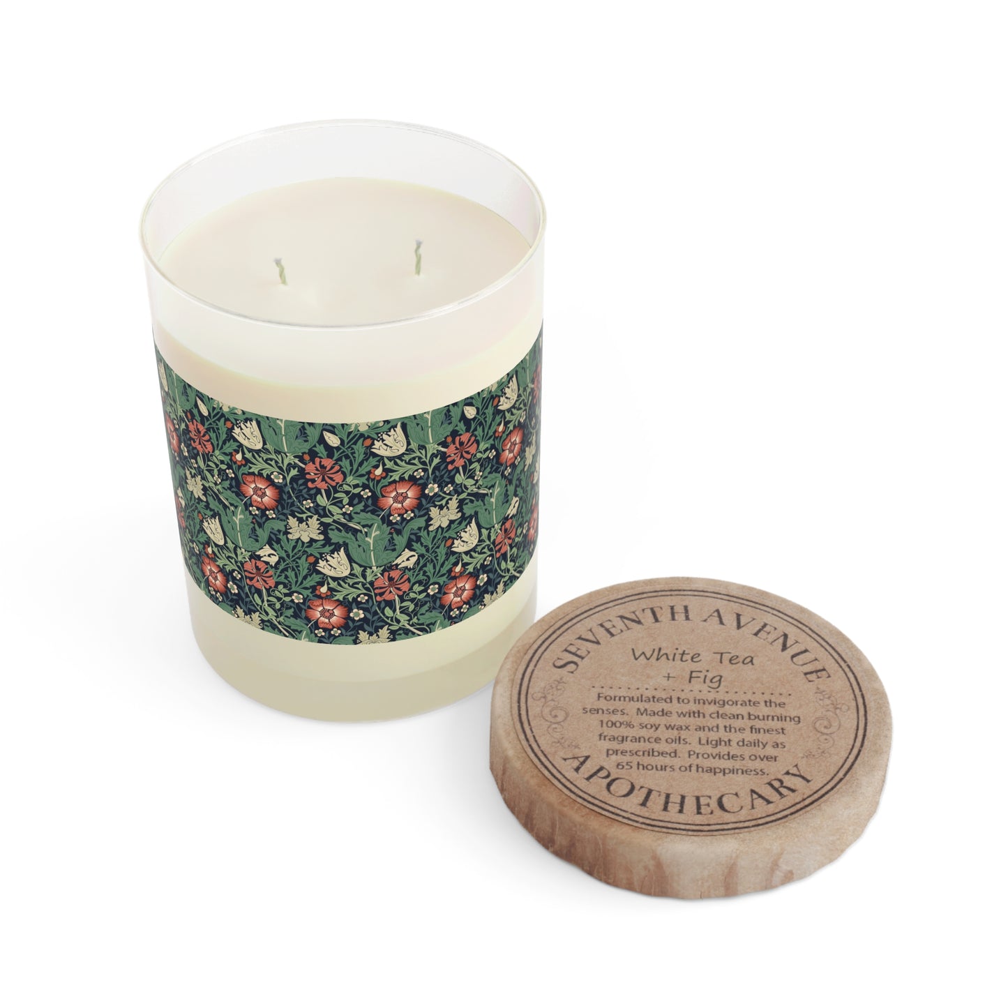 A clear glass scented candle with a floral patterned label and a brown cardboard lid, labeled 'Seventh Avenue White Tea & Fig'.